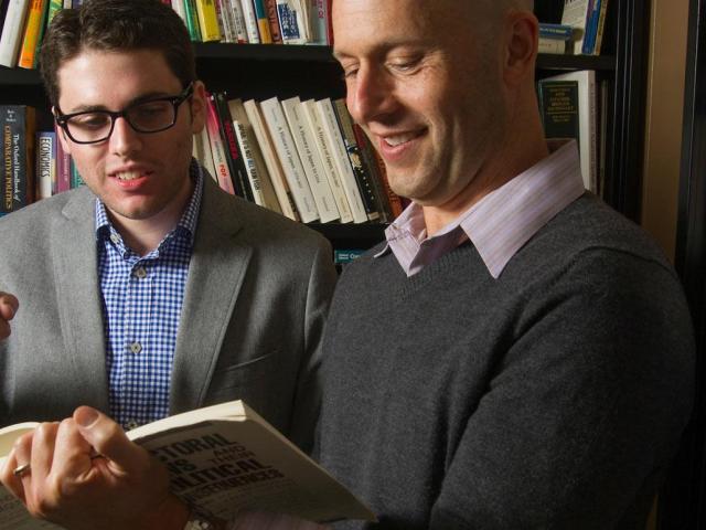 2 faculty looking at books